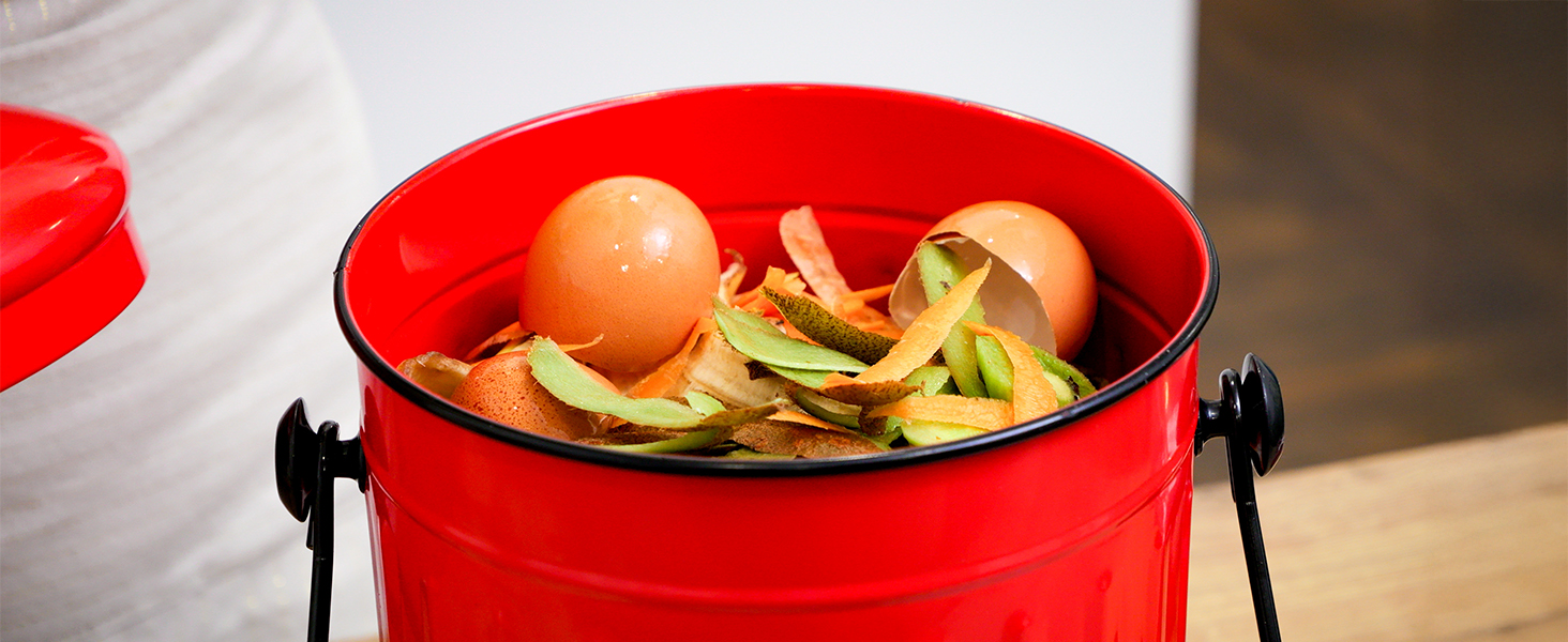 Kitchen scraps collected in red compost bin
