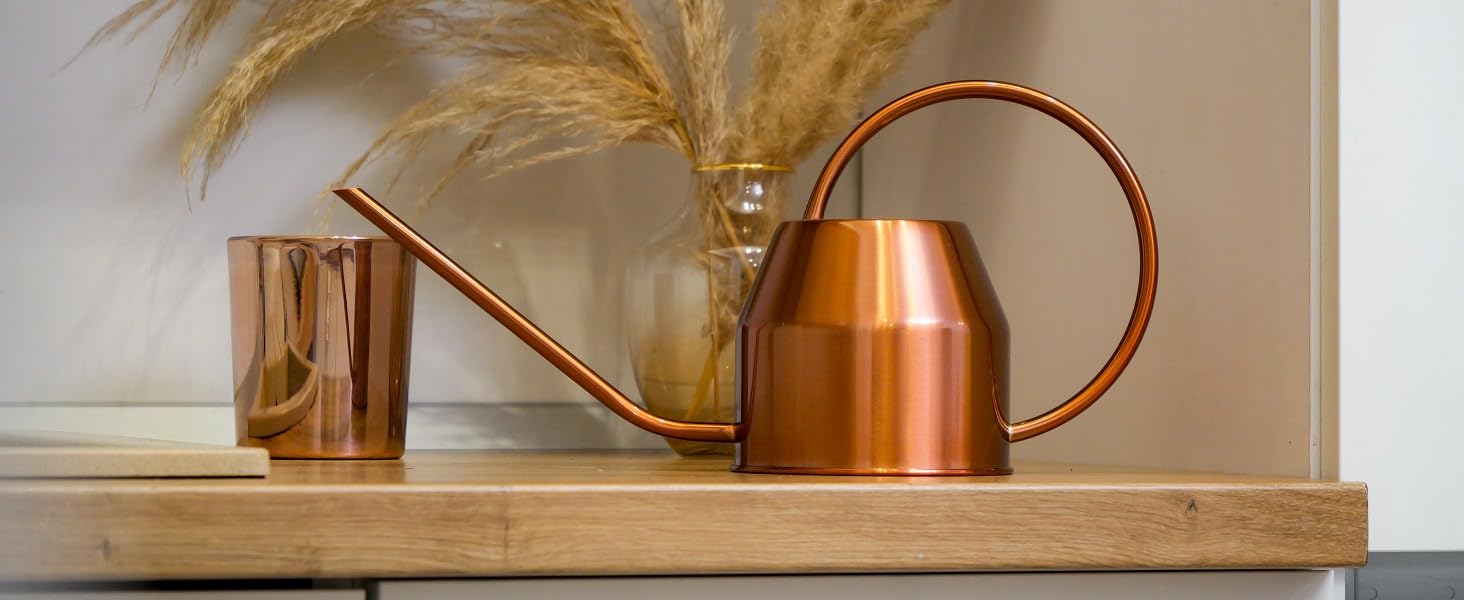 Rose gold watering can in dining room and kitchen setting