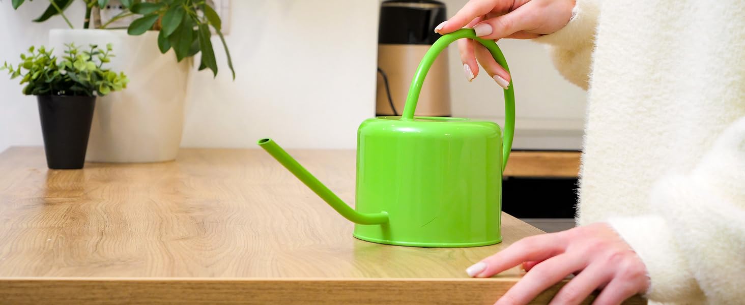 Green watering can in living room and bedroom setting
