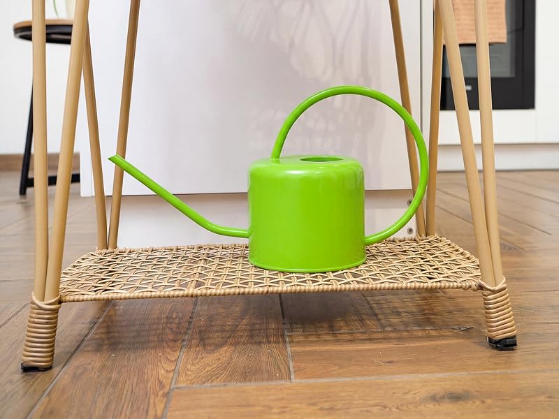 Green watering can displayed in a home setting