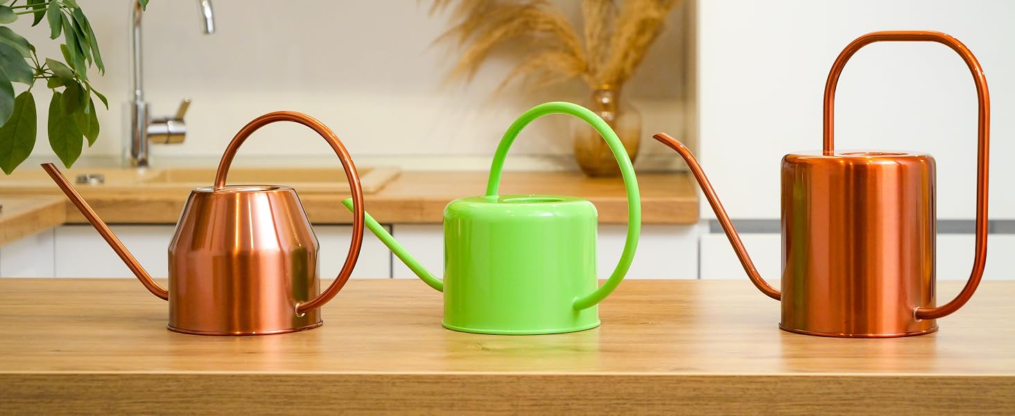 Three watering cans in different colors